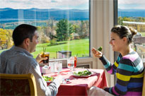 A couple eating near the windows at the Hilltop Restaurant