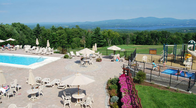 A view of the outdoor pool deck at Steele Hill overlooking the lakes and mountains
