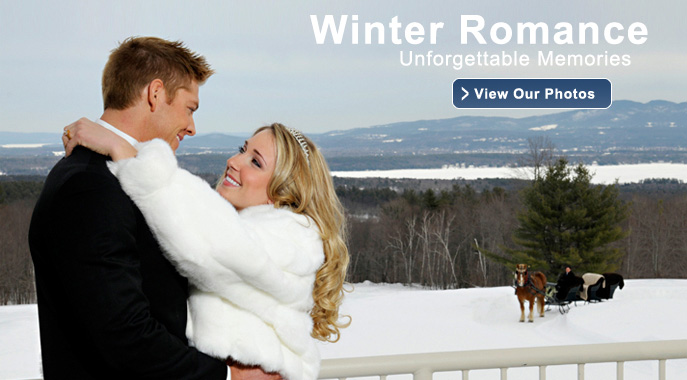 A wedding couple shares a moment overlooking the snowy mountains and lakes from the deck at the Hilltop Restaurant