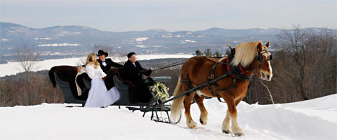 A wedding kiss with a backdrop of lakes and mountains.